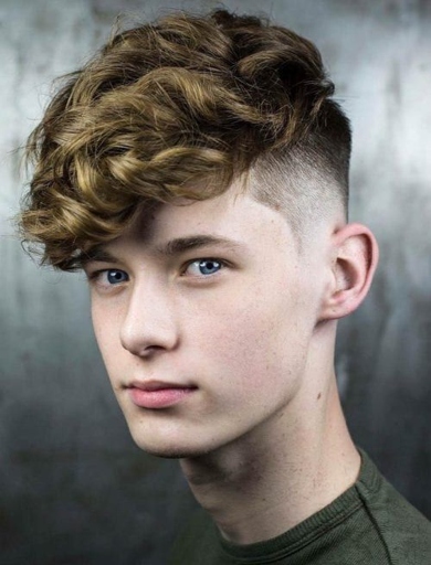 A curly fringe can add a lot of personality to a haircut and is a popular choice for teenage guys.