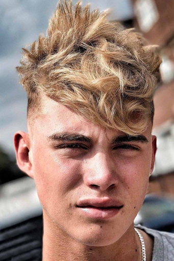 A messy fringe is a popular hairstyle for teenage guys.