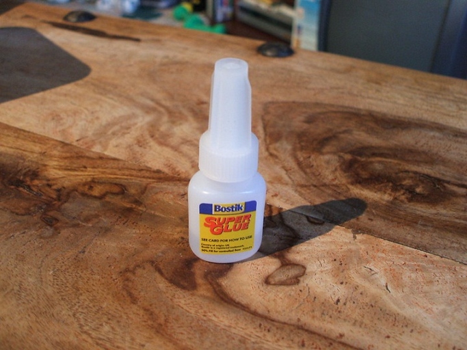 Super glue will dry in air, but the time it takes for it to dry will vary depending on the humidity and temperature.