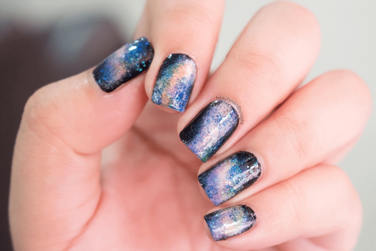 To achieve the galaxy nail look, you will need a black, blue, and white polish, as well as a glitter polish.