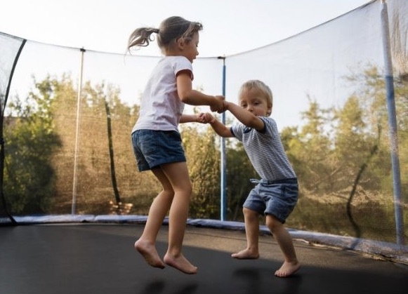To play, stand with your feet together on the trampoline and jump to the side, landing on your feet. This game is simple and can be played with a group or alone. Repeat this jump as many times as you can in a row.